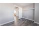 A bedroom features wood flooring, white trim and base molding and a view into the bathroom at 9071 Mount Wilson St, Las Vegas, NV 89113