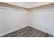 Walk in closet with wood flooring, base molding, a wooden closet rod and white walls at 9071 Mount Wilson St, Las Vegas, NV 89113