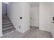 Bright entryway features sleek gray wood-look flooring and staircase leading upstairs at 9071 Mount Wilson St, Las Vegas, NV 89113