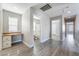 Hallway featuring gray wood-style floors, a built-in desk, and connecting doorways at 9071 Mount Wilson St, Las Vegas, NV 89113
