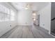 Sunlit living room featuring stylish gray floors, a ceiling fan, and neutral paint palette at 9071 Mount Wilson St, Las Vegas, NV 89113