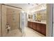 En-suite bathroom features a glass shower, tile surround, and double vanity sink at 9172 Tudor Park Pl, Las Vegas, NV 89145