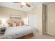 Cozy bedroom features neutral tones, a ceiling fan, and a spacious closet at 9172 Tudor Park Pl, Las Vegas, NV 89145
