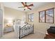 Charming bedroom features a decorative ceiling fan and plenty of natural light from its big windows at 9172 Tudor Park Pl, Las Vegas, NV 89145