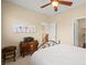 The bedroom features a ceiling fan, neutral walls, and access to more living spaces at 9172 Tudor Park Pl, Las Vegas, NV 89145