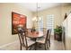 Traditional dining room features a wood table with seating for six and decorative lighting fixture at 9172 Tudor Park Pl, Las Vegas, NV 89145