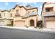 Stylish two-story house featuring tan stucco, arched entryway, and a convenient two-car garage at 9172 Tudor Park Pl, Las Vegas, NV 89145