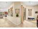Hallway with tile flooring, neutral paint, and ample natural light from nearby windows at 9172 Tudor Park Pl, Las Vegas, NV 89145