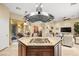 Spacious kitchen with granite countertops, island cooktop, and an open floor plan at 9172 Tudor Park Pl, Las Vegas, NV 89145