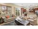 Open concept living area with kitchen access, comfortable seating, and natural light at 9172 Tudor Park Pl, Las Vegas, NV 89145