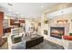 Open-concept space with living area featuring a fireplace, seating, and connection to the kitchen at 9172 Tudor Park Pl, Las Vegas, NV 89145