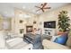 Inviting living room featuring a cozy fireplace, comfortable seating, and a neutral color palette at 9172 Tudor Park Pl, Las Vegas, NV 89145
