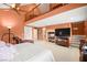Well-lit main bedroom features plush carpet, cozy seating, and a decorative ceiling fan at 9172 Tudor Park Pl, Las Vegas, NV 89145