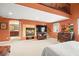 Open-concept main bedroom with a fireplace, carpeted floors, and view of an upstairs loft at 9172 Tudor Park Pl, Las Vegas, NV 89145