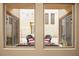 Outdoor patio features stylish seating and cozy string lights, visible through a large window at 9172 Tudor Park Pl, Las Vegas, NV 89145