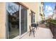 A cozy outdoor patio with a grill and a black metal bistro set, perfect for relaxation and entertainment at 9172 Tudor Park Pl, Las Vegas, NV 89145