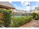 Inviting community pool surrounded by lush landscaping and wrought iron fencing at 9172 Tudor Park Pl, Las Vegas, NV 89145