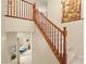 View of staircase with wood handrail and posts, carpeted steps, and neutral walls at 9172 Tudor Park Pl, Las Vegas, NV 89145