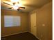 This bedroom features neutral walls, a window with blinds, and a ceiling fan with light at 9359 Brigham Ave, Las Vegas, NV 89178