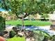 Lush community park featuring manicured lawns, mature trees, and inviting benches at 9359 Brigham Ave, Las Vegas, NV 89178