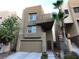 Modern two-story home featuring a front-facing garage, a balcony and desert landscaping at 9359 Brigham Ave, Las Vegas, NV 89178