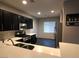 Modern kitchen with stainless steel appliances, dark cabinets and open layout at 9359 Brigham Ave, Las Vegas, NV 89178