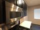 Gourmet kitchen featuring modern stainless steel microwave and dark cabinets at 9359 Brigham Ave, Las Vegas, NV 89178
