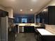 Well-lit kitchen featuring stainless steel appliances, dark cabinetry, and light countertops at 9359 Brigham Ave, Las Vegas, NV 89178
