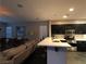 Open-concept living area showcasing a modern kitchen with sleek black cabinetry and barstool seating at 9359 Brigham Ave, Las Vegas, NV 89178