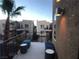 Outdoor patio with seating area and view of nearby buildings and palm trees at 9359 Brigham Ave, Las Vegas, NV 89178