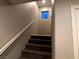 Interior staircase with carpeted steps and white railing at 9359 Brigham Ave, Las Vegas, NV 89178