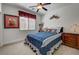 Cozy bedroom featuring a ceiling fan, window with blinds, and a comfortable bed with decorative pillows and bedspread at 949 Via Stellato St, Henderson, NV 89011