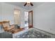 Comfortable bedroom with hardwood floors, ceiling fan, rocker, and a door to the outside at 949 Via Stellato St, Henderson, NV 89011