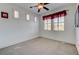 Well-lit bedroom with a ceiling fan and multiple windows, offering ample natural light and creating an open, inviting space at 949 Via Stellato St, Henderson, NV 89011