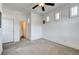 Neutral bedroom features carpet, three windows, and ceiling fan at 949 Via Stellato St, Henderson, NV 89011