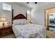 Cozy bedroom with four poster bed, bedside lamps, and decor with an entrance to another room at 949 Via Stellato St, Henderson, NV 89011