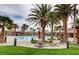 Resort style community pool and lounge area surrounded by tropical palm trees at 949 Via Stellato St, Henderson, NV 89011