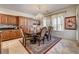 Dining area with chandelier lighting, wood table and chairs, and travertine flooring at 949 Via Stellato St, Henderson, NV 89011