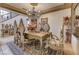 Luxurious dining room with a large chandelier, decorative mirror, and elegant furnishings at 949 Via Stellato St, Henderson, NV 89011