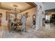 Formal dining room featuring a chandelier, decorative mirrors, and ornate furnishings at 949 Via Stellato St, Henderson, NV 89011