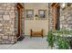 Charming entrance with stone accents and a cozy wooden bench at 949 Via Stellato St, Henderson, NV 89011