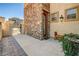Exterior showcasing stone accents, a gate, a bench, potted plants, and a brick walkway at 949 Via Stellato St, Henderson, NV 89011