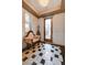 Elegant foyer with decorative tile flooring, stained glass door, and stylish furnishings at 949 Via Stellato St, Henderson, NV 89011