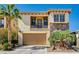Charming two-story home with a stone facade, balcony, and well-manicured landscaping at 949 Via Stellato St, Henderson, NV 89011