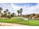 Lush golf course view featuring palm trees, a water feature, and a bronze horse sculpture at 949 Via Stellato St, Henderson, NV 89011
