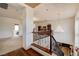 Upstairs hallway with a wrought iron railing and chandelier lighting at 949 Via Stellato St, Henderson, NV 89011