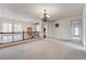 Bright hallway featuring a decorative chandelier and an elegant wooden banister with iron spindles at 949 Via Stellato St, Henderson, NV 89011