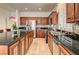 Kitchen featuring stainless steel appliances, granite countertops, and wood cabinets at 949 Via Stellato St, Henderson, NV 89011