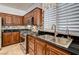 Close-up of a modern kitchen with tile backsplash, stainless steel sink, and gas stove at 949 Via Stellato St, Henderson, NV 89011