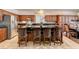 Kitchen island with granite countertop and seating, complemented by wood cabinetry at 949 Via Stellato St, Henderson, NV 89011